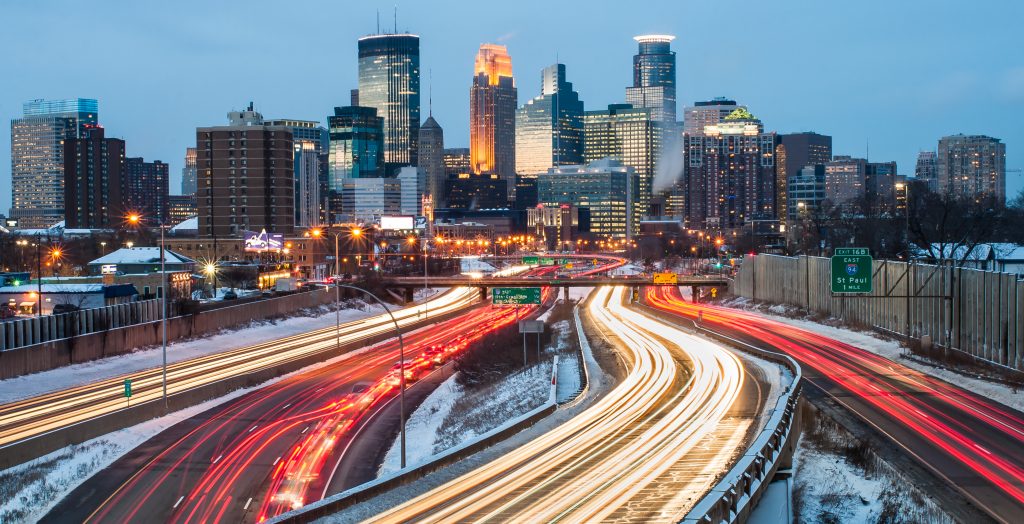 Snowy overlook of Minnesota city with buildings and highways.